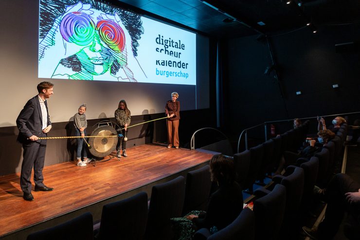 Gedeputeerden Floor Vermeulen en Willy de Zoete lanceerden samen met vmbo-leerlingen Sennah en Naomi op 27 oktober in het Filmhuis Den Haag de Digitale Scheurkalender Burgerschap door op een grote gong te slaan